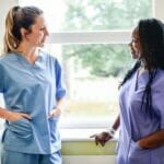 Nurses having a conversation in the hospital hallway